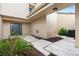 Beautiful front entryway featuring a charming door, beige siding, and lush tropical landscaping at 106 Madrid Dr, Casselberry, FL 32707