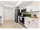 Stylish kitchen with white cabinets, stainless steel appliances, and tile flooring at 106 Madrid Dr, Casselberry, FL 32707
