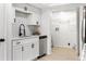 Modern kitchen with white cabinets, quartz counters, and stainless steel appliances at 106 Madrid Dr, Casselberry, FL 32707