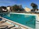 A community pool features clear, blue water and lounge chairs under a bright, sunny sky at 106 Madrid Dr, Casselberry, FL 32707