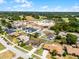 Aerial view of a home and its neighborhood, highlighting the proximity to a golf course and other community amenities at 1132 Feather Dr, Deltona, FL 32725