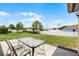 Spacious backyard features a table with chairs and white vinyl fencing, perfect for outdoor entertaining at 1132 Feather Dr, Deltona, FL 32725