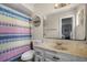 Bathroom featuring a vanity, toilet, mirror, and colorful shower curtain at 1132 Feather Dr, Deltona, FL 32725