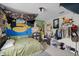 Eclectic bedroom featuring lots of decorations, a large window, and a study area at 1132 Feather Dr, Deltona, FL 32725