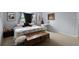 Bright bedroom with a trunk at the foot of the bed, a writing desk, and neutral-colored walls at 1132 Feather Dr, Deltona, FL 32725