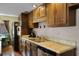 Traditional kitchen featuring wood cabinets, stainless steel appliances, stone countertops and hardwood flooring at 1132 Feather Dr, Deltona, FL 32725