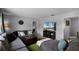Comfortable living area with a large TV, neutral walls, and a cozy sectional sofa at 1132 Feather Dr, Deltona, FL 32725
