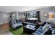 Inviting living room featuring a large sectional couch, bright natural light, and cozy decor at 1132 Feather Dr, Deltona, FL 32725