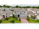Aerial view of a neighborhood featuring a two-story home with manicured lawn at 1317 Yorkdale Rd, Davenport, FL 33837