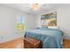Comfortable bedroom featuring a cozy bed and a charming window view at 1532 Lawndale Cir, Winter Park, FL 32792