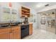 Cozy kitchen with wood cabinets, black appliances, and sliding doors to the outdoors at 1532 Lawndale Cir, Winter Park, FL 32792