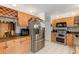 Functional kitchen with stainless steel appliances, wood cabinets, and wine storage at 1532 Lawndale Cir, Winter Park, FL 32792