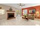 Comfortable living room with a fireplace, tile floors, and access to a patio at 1532 Lawndale Cir, Winter Park, FL 32792