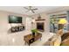 Inviting living room with a fireplace, tile floors, and a view of the screened-in pool at 1532 Lawndale Cir, Winter Park, FL 32792