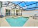 Relaxing screened-in pool area with outdoor seating and chaise lounge, perfect for enjoying sunny days at 1571 Plunker Dr, Davenport, FL 33896