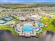 Beautiful aerial view of a community pool, clubhouse, and surrounding neighborhood at 6137 Blue Pond Way, St Cloud, FL 34771