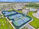 Scenic aerial view of community pickleball courts, clubhouse and a glimpse of the pool at 6137 Blue Pond Way, St Cloud, FL 34771