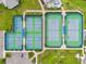 An aerial view of a pickleball court with green and blue surface surrounded by lush landscaping at 6137 Blue Pond Way, St Cloud, FL 34771