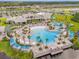 Expansive community pool area with multiple pools, lounge areas, and lush landscaping at 6137 Blue Pond Way, St Cloud, FL 34771