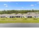 A serene view of the home overlooking a tranquil pond and lush landscaping at 6137 Blue Pond Way, St Cloud, FL 34771