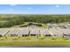 An aerial view shows the community nestled by a picturesque pond and surrounding greenery at 6137 Blue Pond Way, St Cloud, FL 34771
