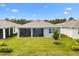A well-manicured backyard with a screened-in lanai offers an inviting outdoor living space at 6137 Blue Pond Way, St Cloud, FL 34771
