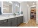 Bathroom with a double sink vanity with modern fixtures and a walk-in closet at 6137 Blue Pond Way, St Cloud, FL 34771