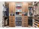 Custom closet with wood cabinets, drawers, shelving and double hanging racks at 6137 Blue Pond Way, St Cloud, FL 34771
