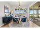 Contemporary dining room with lake view, stylish furnishings, and sliding glass doors at 6137 Blue Pond Way, St Cloud, FL 34771