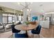 Inviting dining room with modern light fixture, leading to an outdoor patio and kitchen at 6137 Blue Pond Way, St Cloud, FL 34771
