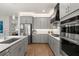 Modern kitchen features gray cabinetry, stainless steel appliances and light countertops at 6137 Blue Pond Way, St Cloud, FL 34771