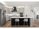 Stylish gray kitchen featuring stainless steel appliances, a center island with seating, and pendant lighting at 6137 Blue Pond Way, St Cloud, FL 34771