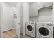 Well-equipped laundry room featuring modern washer and dryer units and ample storage at 6137 Blue Pond Way, St Cloud, FL 34771