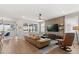Bright living area with a large leather sofa, modern TV wall, and view into the dining area at 6137 Blue Pond Way, St Cloud, FL 34771