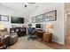 Bright home office with a comfortable chair, sleek desk setup, and wall-mounted TV at 6137 Blue Pond Way, St Cloud, FL 34771