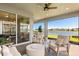 Relaxing patio with comfortable seating, a fire pit, and a beautiful water view at 6137 Blue Pond Way, St Cloud, FL 34771