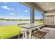 Charming patio featuring a dining table and scenic views of the peaceful lake at 6137 Blue Pond Way, St Cloud, FL 34771