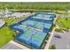 Aerial view of neighborhood pickleball courts, perfect for active residents and community fun at 6137 Blue Pond Way, St Cloud, FL 34771