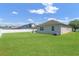 Spacious backyard with a well-maintained lawn, white fence, and patio area at 972 Bighorn St, Oviedo, FL 32765