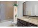 Well-lit bathroom with a granite countertop, tiled walls, and modern fixtures at 972 Bighorn St, Oviedo, FL 32765