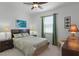 Bright bedroom with a tropical theme features a palm leaf patterned bedspread and curtains at 972 Bighorn St, Oviedo, FL 32765