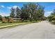 Brick community entrance sign with manicured landscaping on a tree lined street at 972 Bighorn St, Oviedo, FL 32765