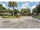 Gated community entrance with brick pillars, lush trees, and manicured landscaping at 972 Bighorn St, Oviedo, FL 32765