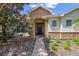 Home's entry with decorative stone archway, beautiful door with wreath, and well-maintained landscape at 972 Bighorn St, Oviedo, FL 32765