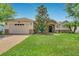Charming single-story home with a lush green lawn, stone accents, and a welcoming front porch at 972 Bighorn St, Oviedo, FL 32765