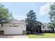 View of the house with a neutral color scheme, front lawn, driveway and a two car garage at 972 Bighorn St, Oviedo, FL 32765