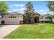 Charming single-story home boasts a lush lawn, brick driveway, and stone accents for added curb appeal at 972 Bighorn St, Oviedo, FL 32765