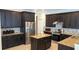 Well-appointed kitchen boasts stainless appliances, granite countertops, tile backsplash, and dark cabinetry at 972 Bighorn St, Oviedo, FL 32765