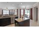 Spacious kitchen with granite countertops, an island, and stainless steel dishwasher overlooking breakfast nook at 972 Bighorn St, Oviedo, FL 32765