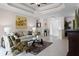 Open living room featuring tile floors, neutral tones, tray ceiling, and access to the main entrance at 972 Bighorn St, Oviedo, FL 32765